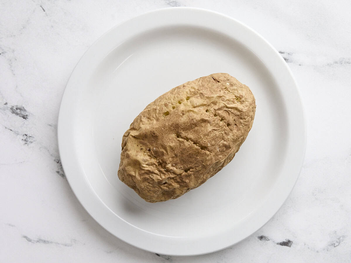 A baked potato on a plate.