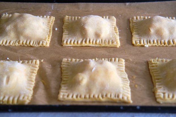 peach hand pies arranged on a sheet before baking