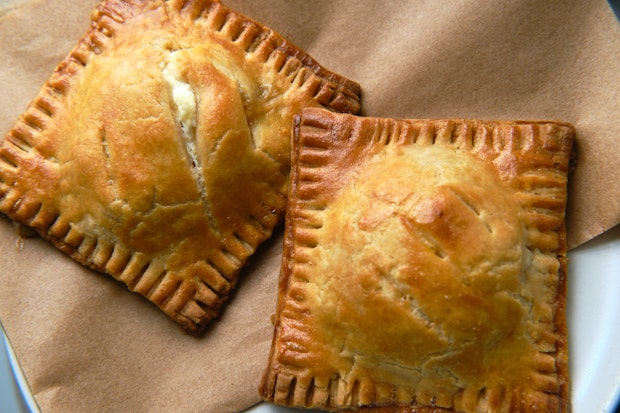 Two peach hand pies on a plate