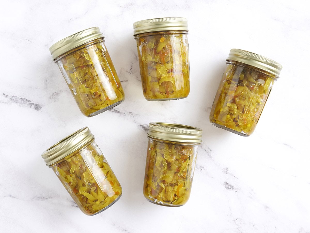 Five canned zucchini relish jars.