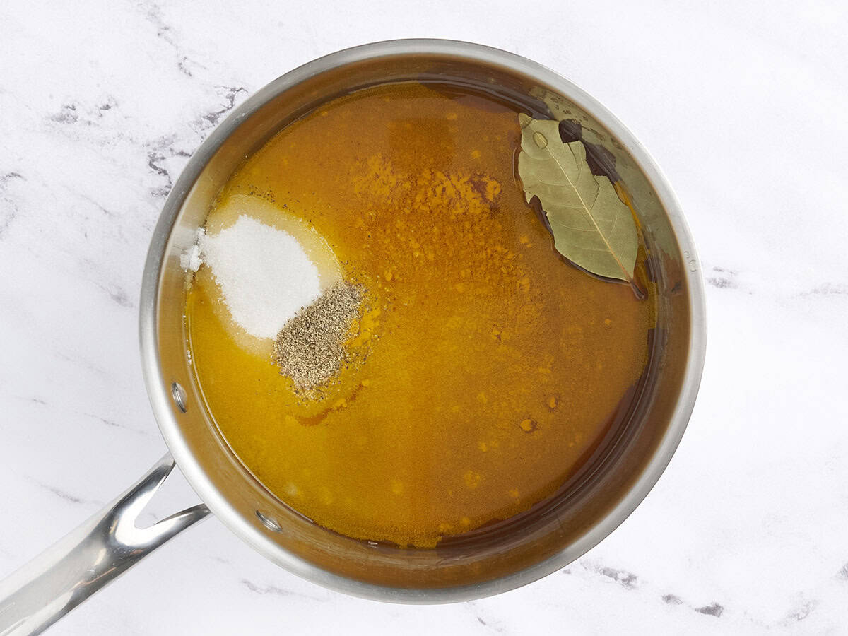 Vinegar, sugar, and spices in a saucepan to make pickling liquid.