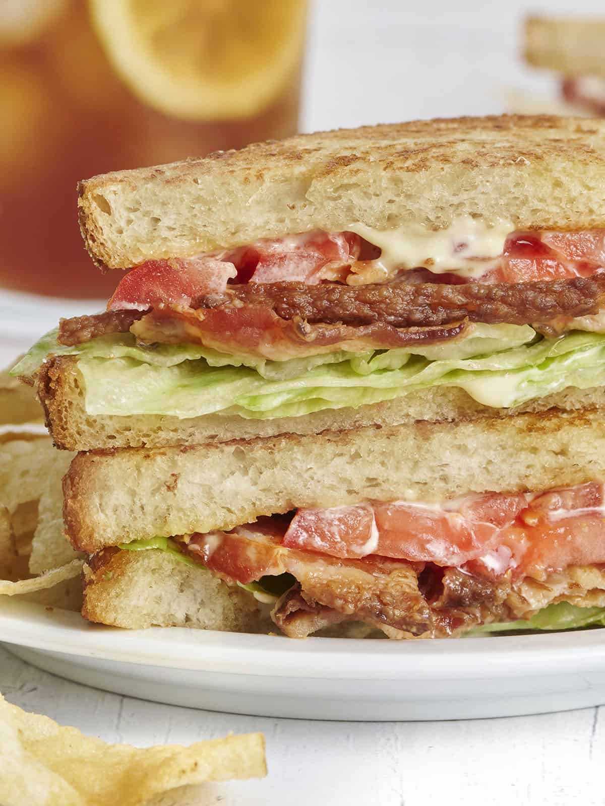 Side close up view of a classic blt sandwich on a plate.