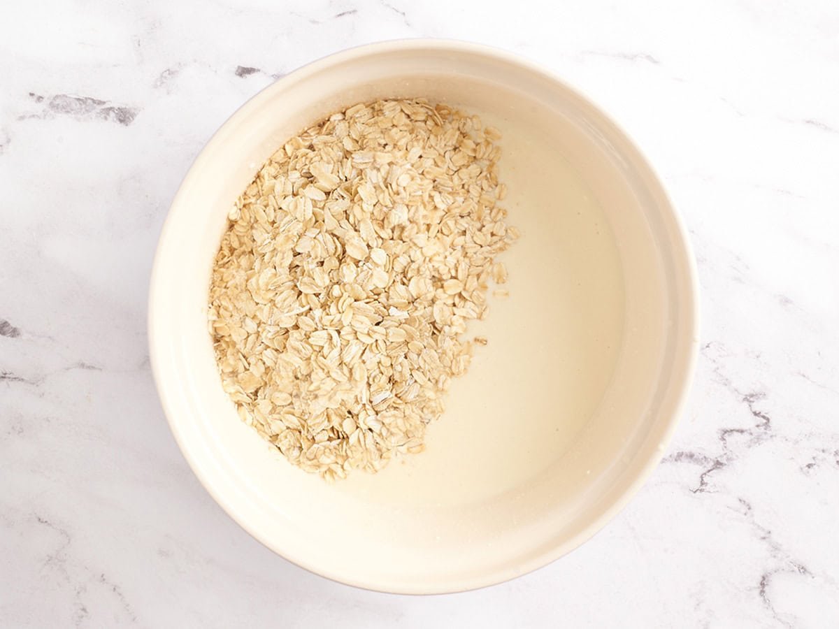 Oats added to the wet ingredients to make baked oatmeal.