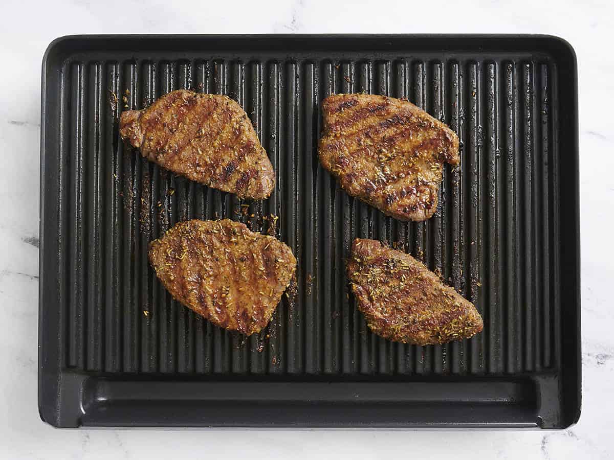 Finished grilled sirloin tender steaks on a grill.