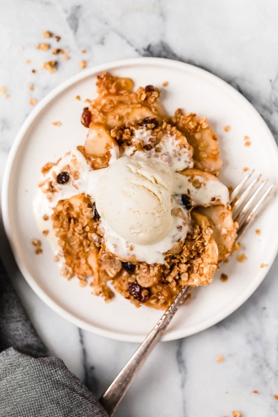 Warm apple crisp with vanilla ice cream on top”