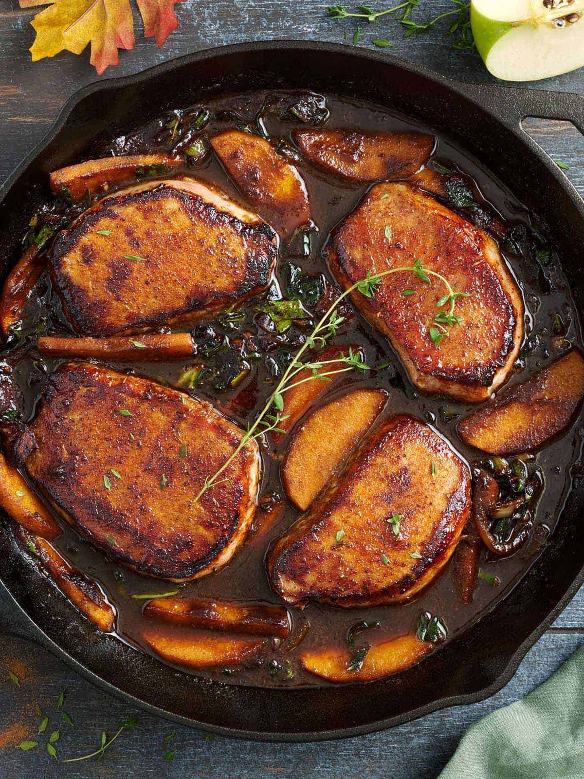 Overhead view of homemade apple butter pork chops in a skillet.