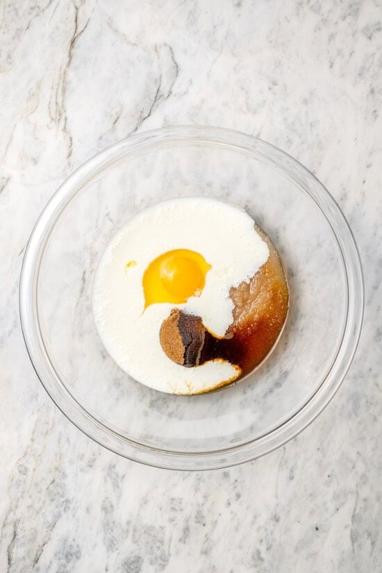 Overhead view of wet ingredients in bowl before mixing