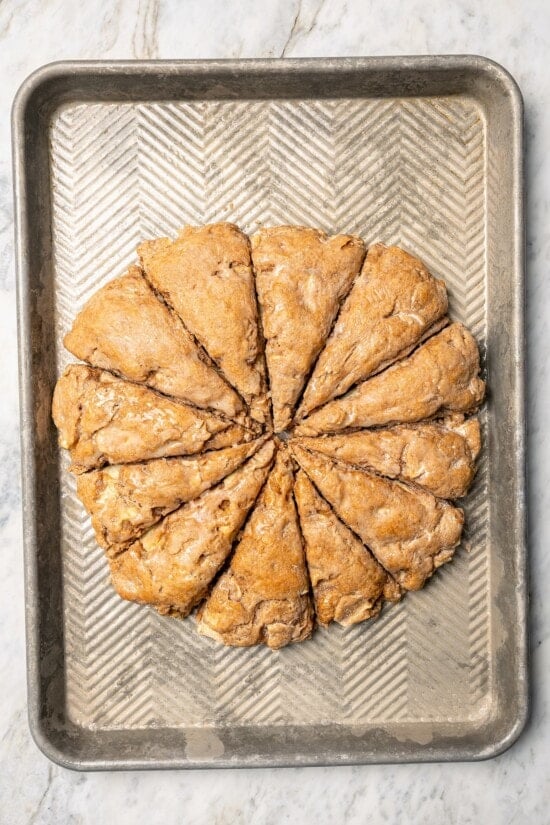Overhead view of baked apple scones on baking sheet