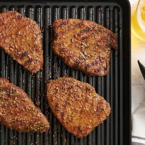 Overhead view of grilled sirloin tender steaks on a grill.
