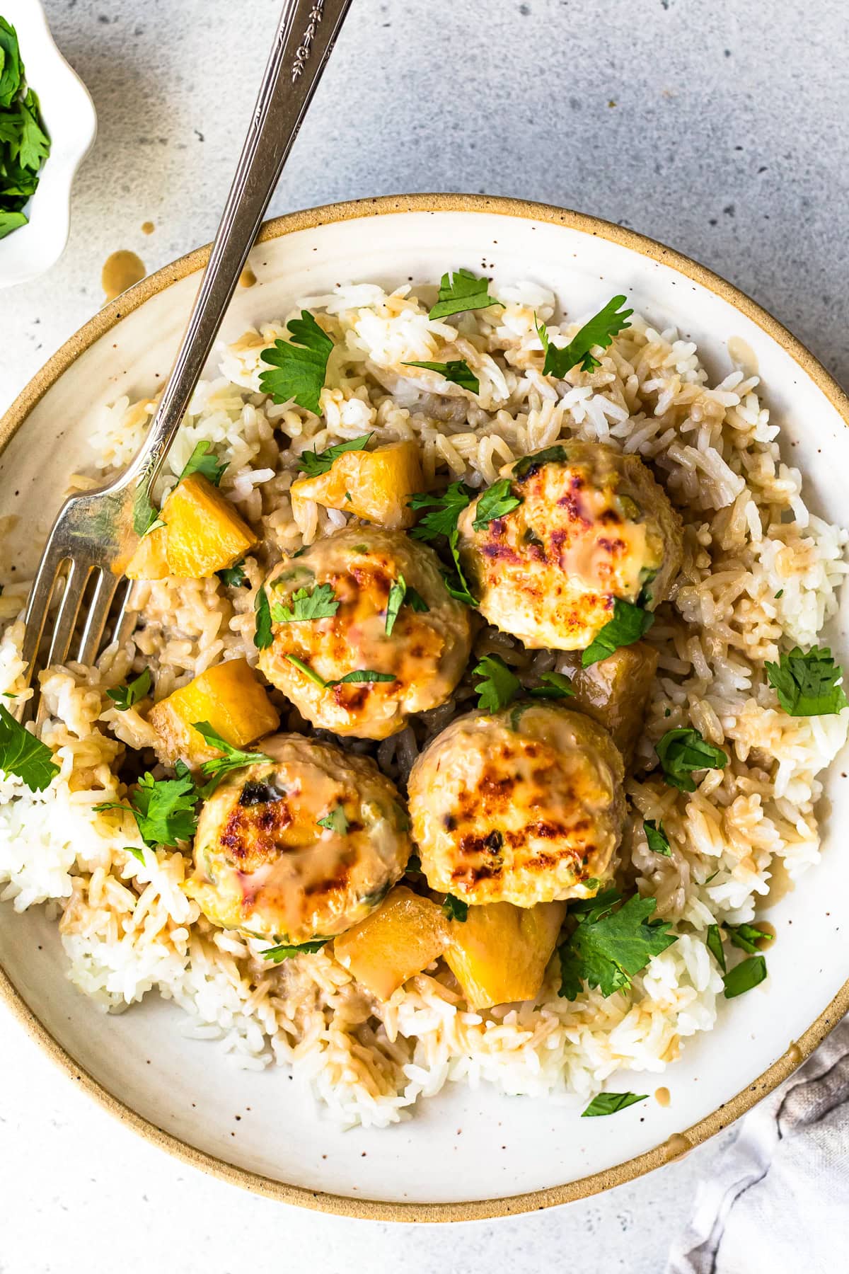 Hawaiian Chicken Meatballs with Pineapple Coconut Sauce over rice