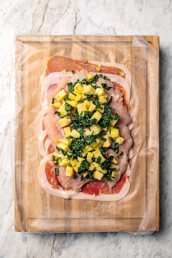 This Prosciutto Wrapped Stuffed Turkey Tenderloin recipe is filled with apples, cheese and kale for a healthy high-protein dinner. Delicious! Kale and apple filling on turkey tenderloin.