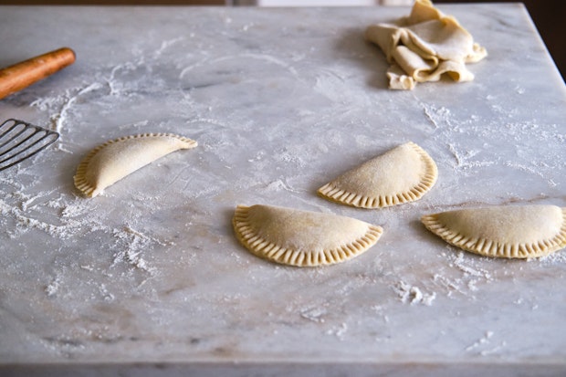 Apple cinnamon hand pies after being filled on floured counter top