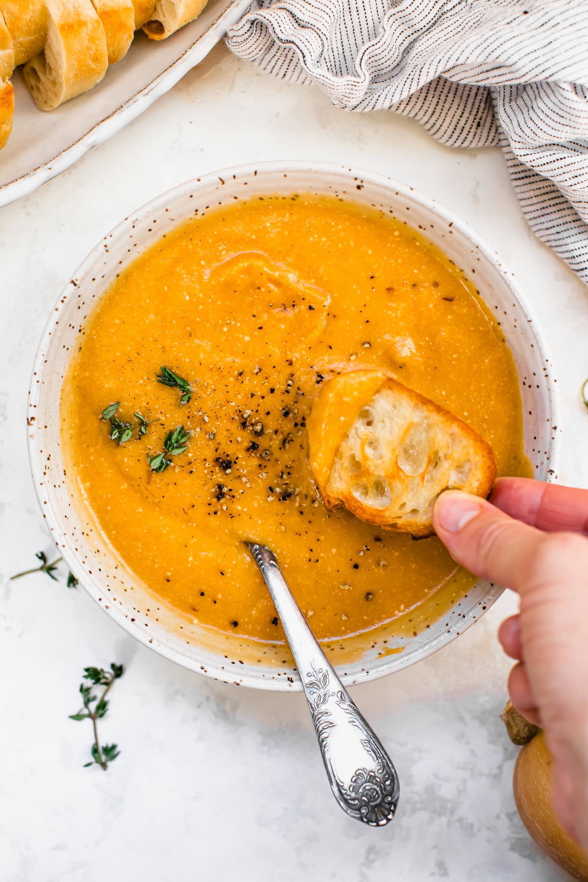 Butternut Squash Cheddar Soup in a bowl with bread