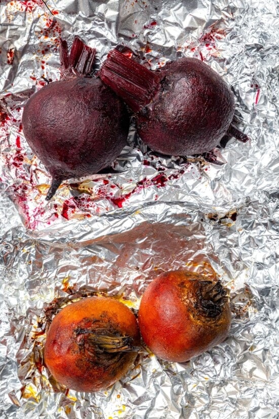 Roasted red and golden beets on foil.