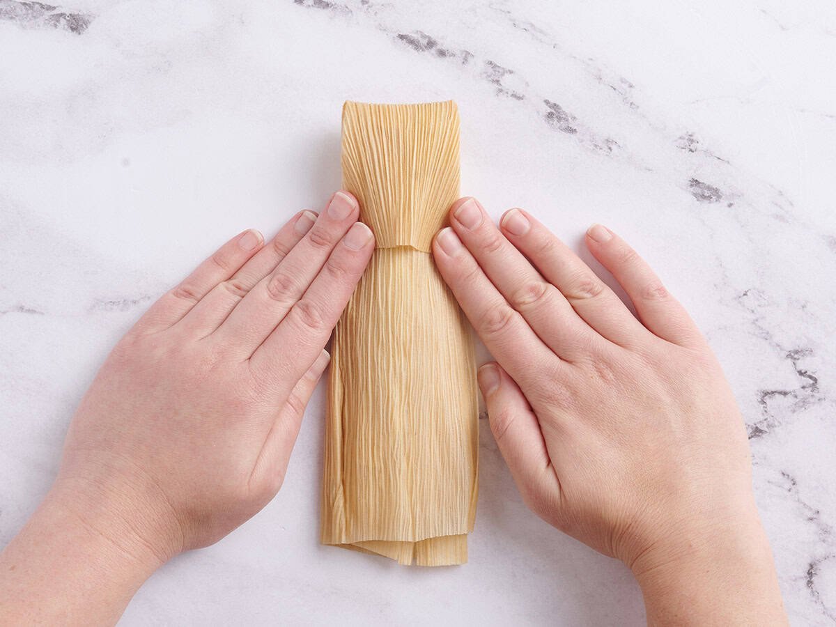 Top of corn husk folded over filling