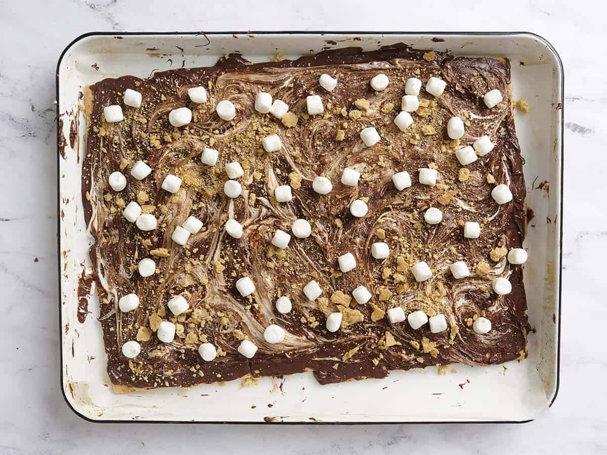 Sprinkling the bark with mini marshmallows. 