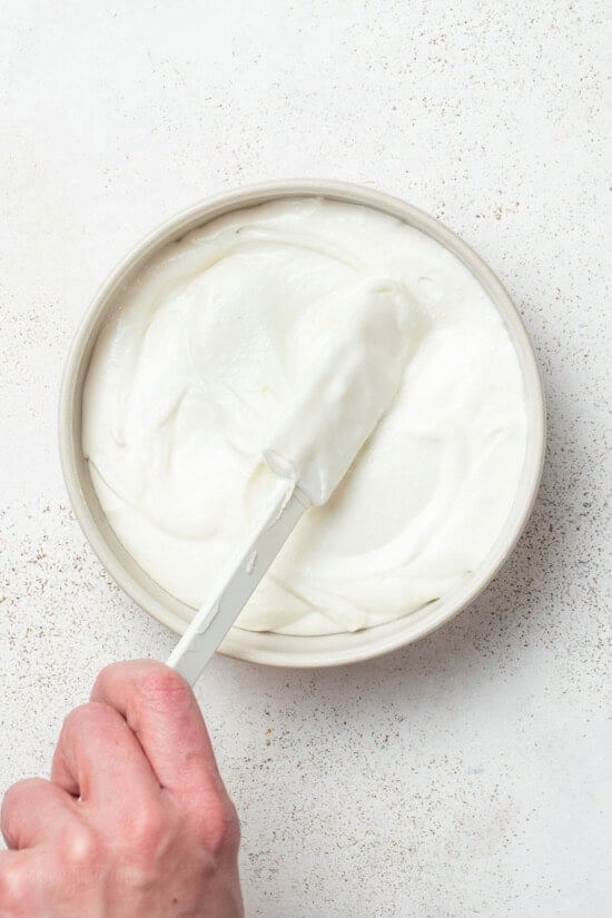 Spreading Whipped Feta Dip on a plate