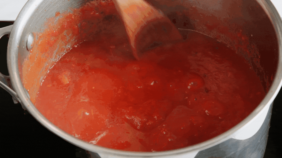 stirring and simmering marinara sauce for meatballs