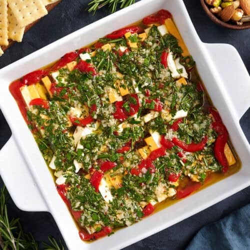 Overhead view of a pan of marinated cheese.