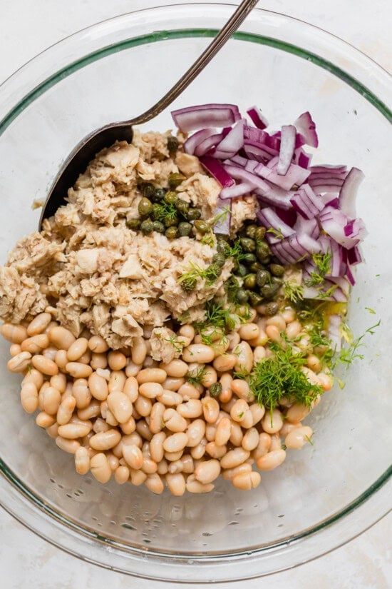 Tuna White Bean Salad in a bowl with capers and onion
