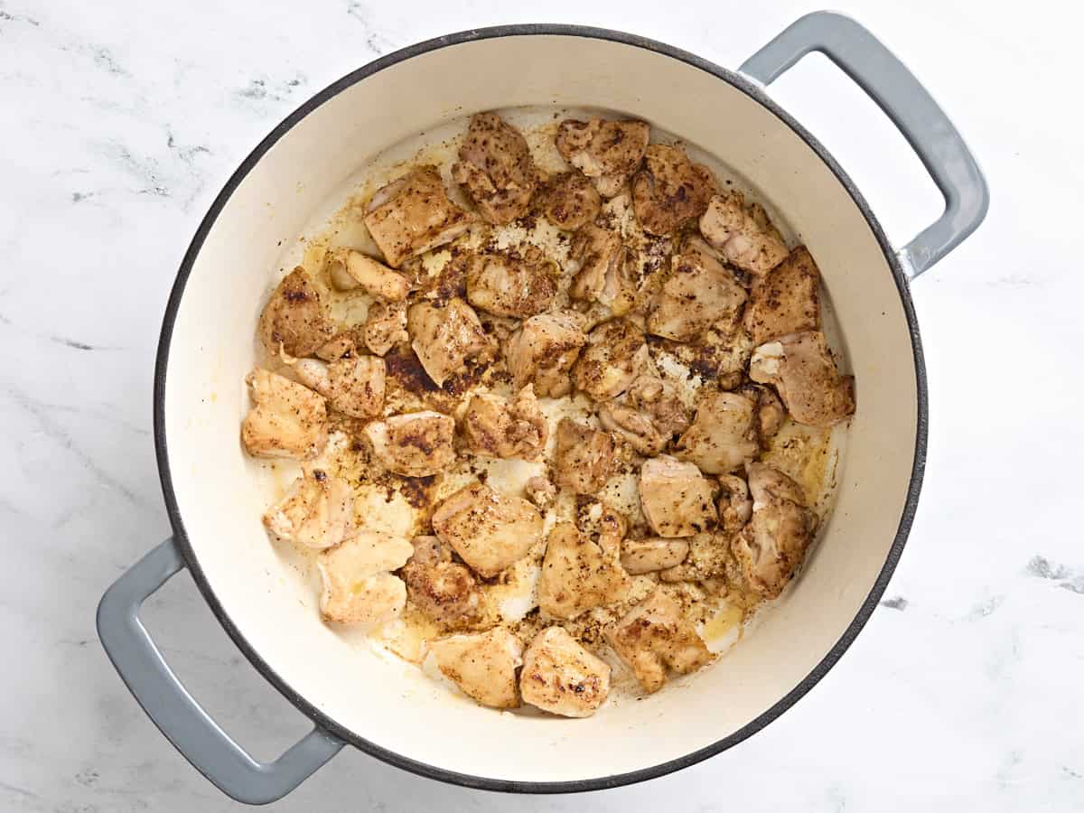 Browned chicken in a skillet.