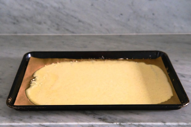 Cottage cheese wrap batter on a rimmed baking sheet before baking